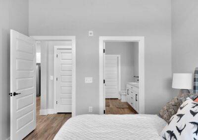 A bedroom with one door leading to the hallway and another door leading to the en-suite bathroom.